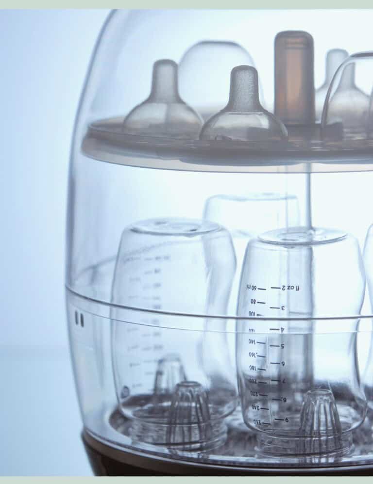 A steriliser filled with baby bottles and teats.