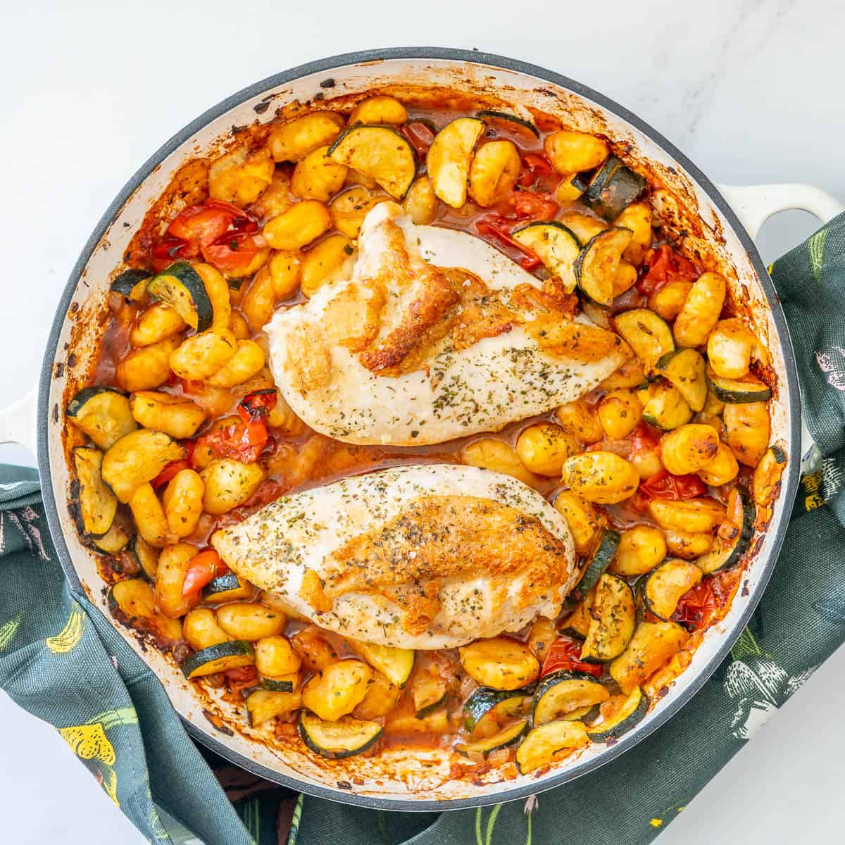 A top down image of chicken and gnoccih bake.