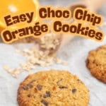 Orange oatmeal cookie with golden edges, wooden scoop of oats and halved orange on benchtop. Text overlay; 'Easy Choc Chip Orange Cookies'.
