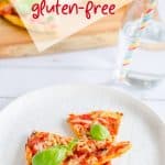 2 slices of pizza on a white plate, topped with tomato cheese and basil