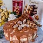A delicious triple layer Christmas chocolate hazelnut ice-cream cake! Chocolate, vanilla and hazelnut flavoured ice-cream layers packed full of Christmas treats, Ferrero Rocher, Guylian Chocolates and More