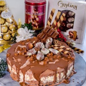 A delicious triple layer Christmas chocolate hazelnut ice-cream cake! Chocolate, vanilla and hazelnut flavoured ice-cream layers packed full of Christmas treats, Ferrero Rocher, Guylian Chocolates and More