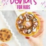 An apple slice with core removed decorated to look like a donut with text overlay; Apple slice donuts, for kids.