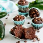 Double Chocolate Zucchini Muffins, 1 muffin cut in half showing moist fudgy consistency