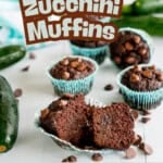 Fudgey chocolate muffins on a bench top with zucchini and choc chips, text overaly; ' Chocolate Zucchini Muffins, you won't believe that are gluten free!'
