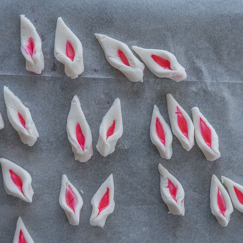Fondant triangles pinched at the bottom to look like unicorn ears.