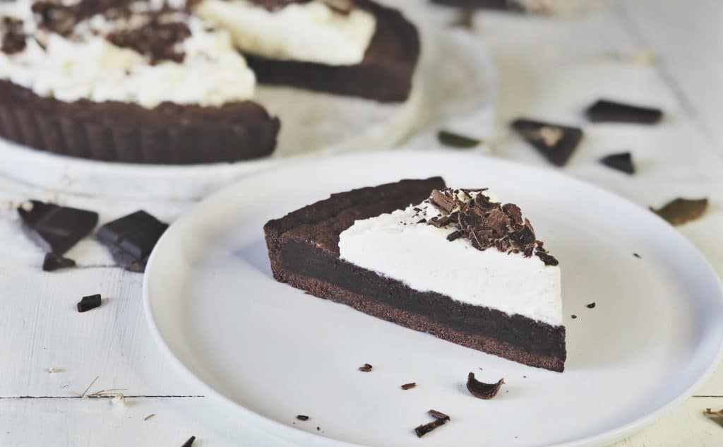 Slice of brownie cream pie on a plate.