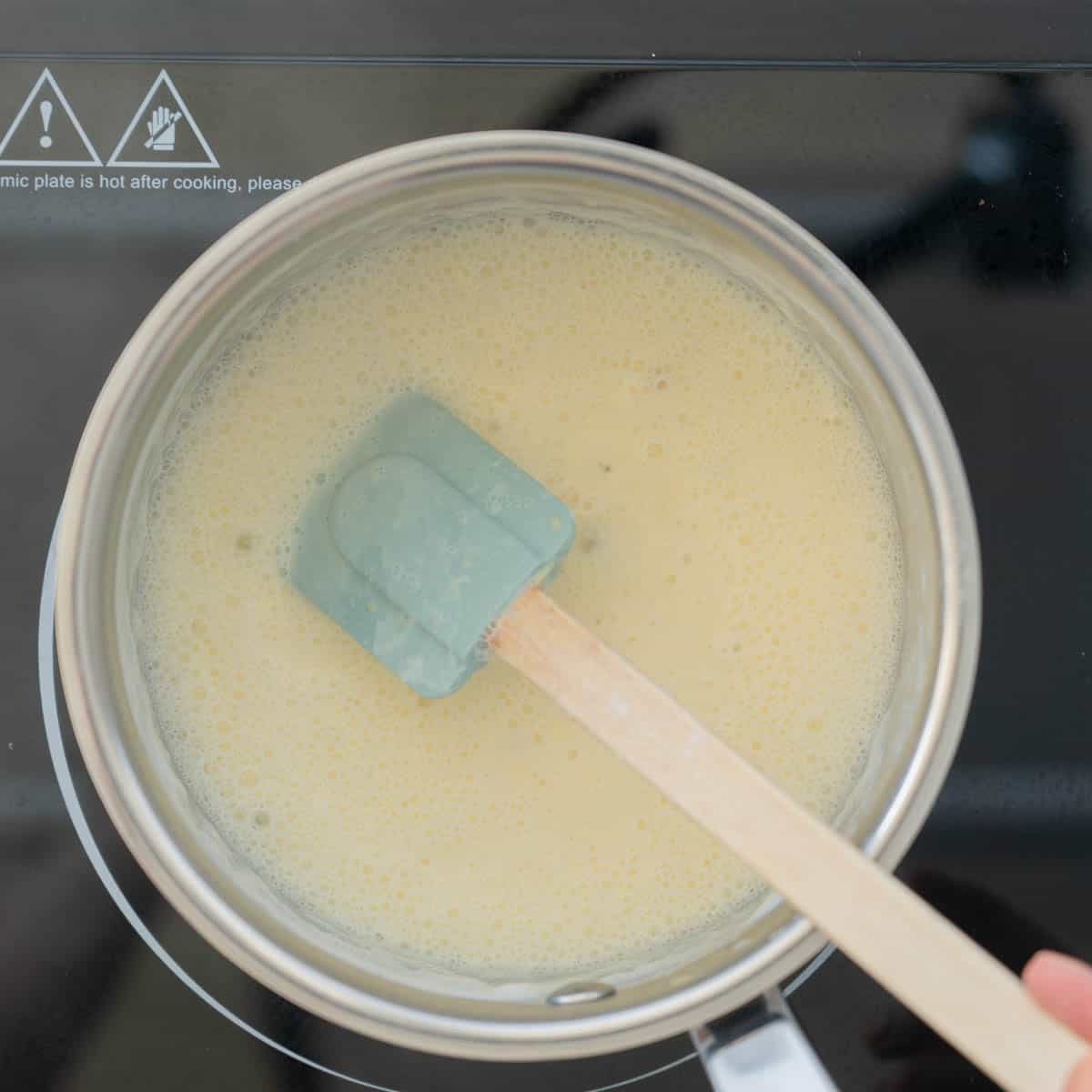 Thickened custard in a saucepan.