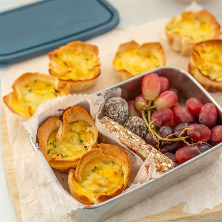 mini quiches in a lunchbox with a granola bar and grapes