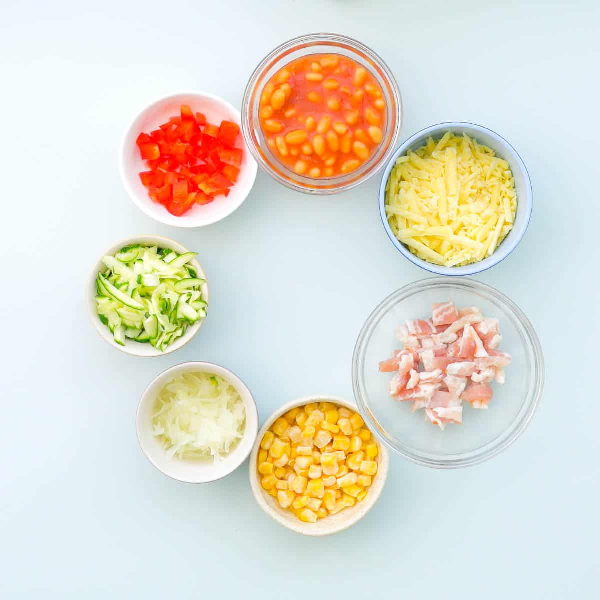 7 different size bowls with all of the ingredient fillings for Bread cases inside.