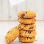 stack of 5 cornflake cookies on a white background, raisins visible.