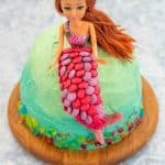 Ombre ocean coloured cake with a mermaid cake topper decorated with colourful sweets