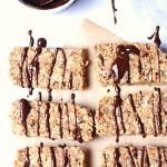 Six protein bars with chocolate drizzled of chocolate on top.