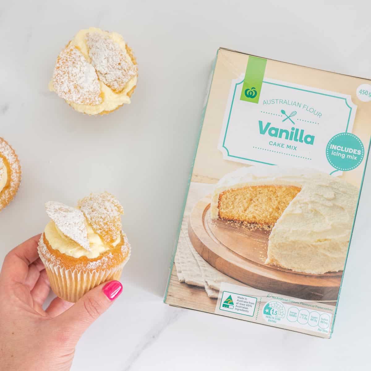 A countdown branded vanilla cake mix box with cupcake in hand