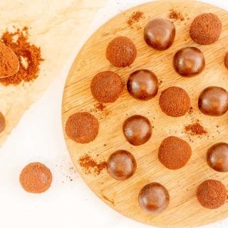 milo balls and chocolate balls on a wooden serving platter.