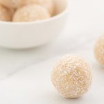 Coconut balls on a white marble bench top.