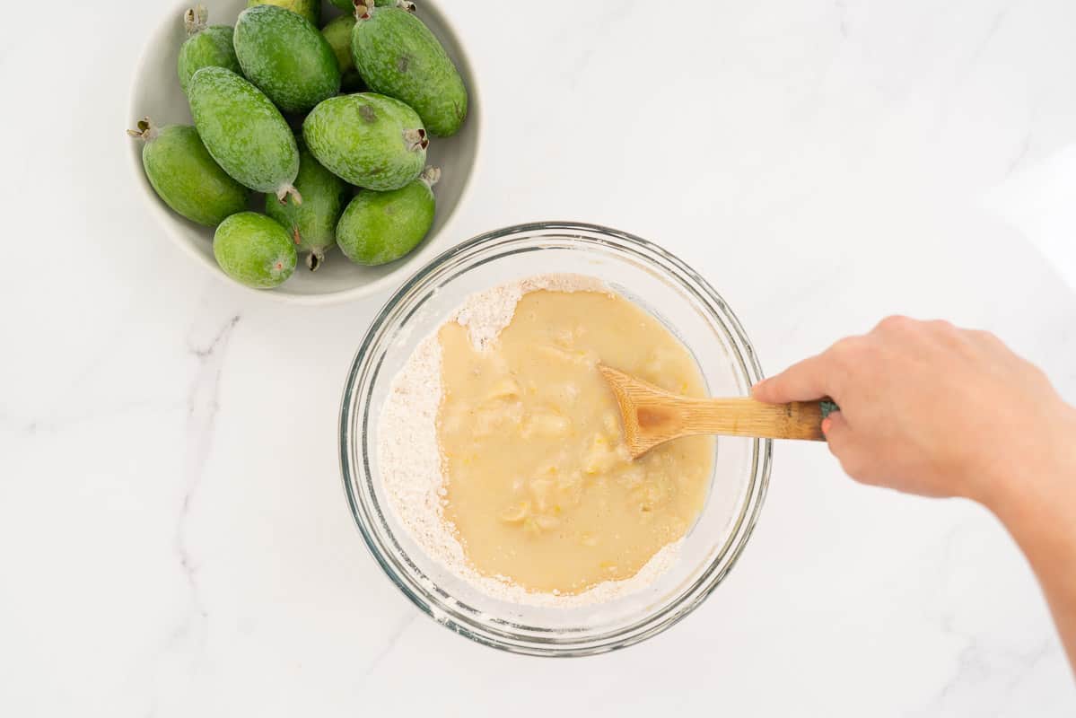 Wet ingredients and dry ingredients in a large glass bowl.