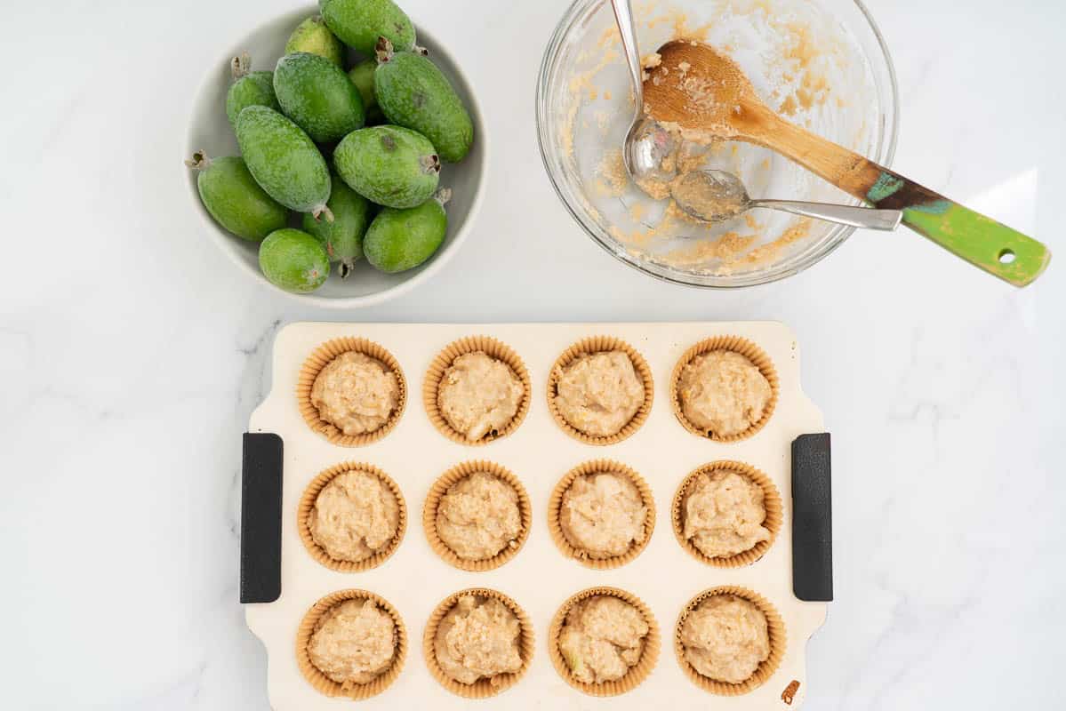 Muffin batter portioned into a 12 cup muffin pan.