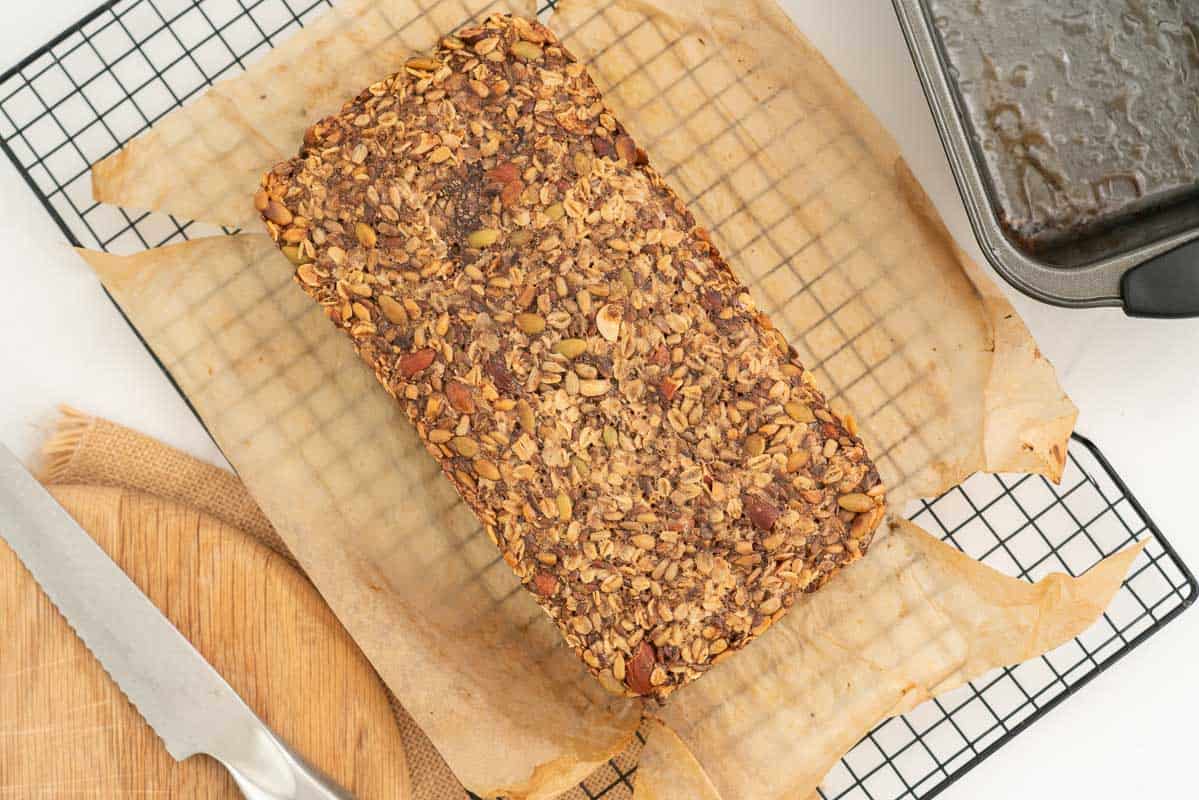 A golden baked loaf on a cooling rack.