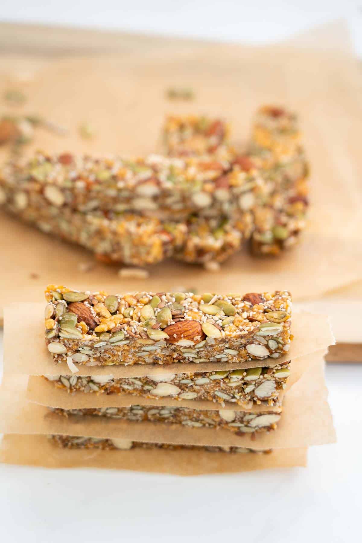 Four energy bars stacked on top of each other, a piece of unbleached baking paper between each bar.