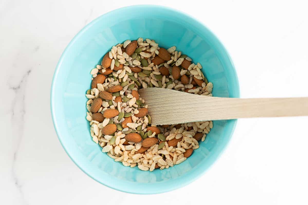 Nuts and seeds in a light blue mixing bowl.