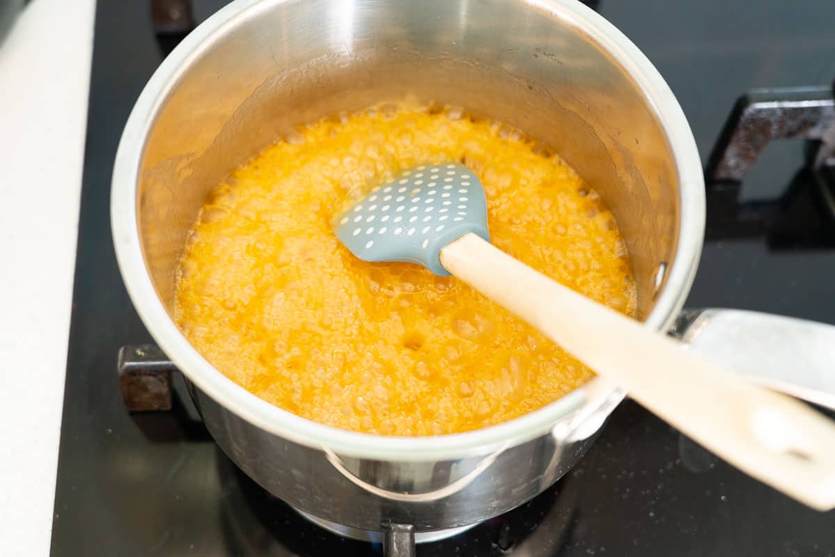 Butter and honey bubbling in the bottom of a saucepan.