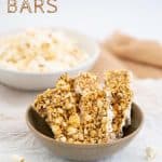 Brown ceramic bowl filled with 6 popcorn bars, a bowl of popcorn in the background with text overlay.