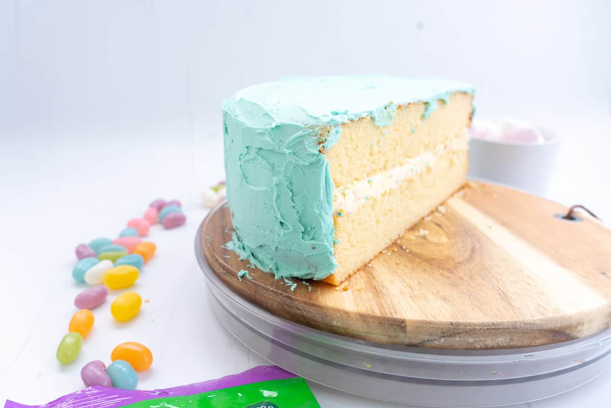 Half round double layer vanilla cake iced with light blue buttercream.
