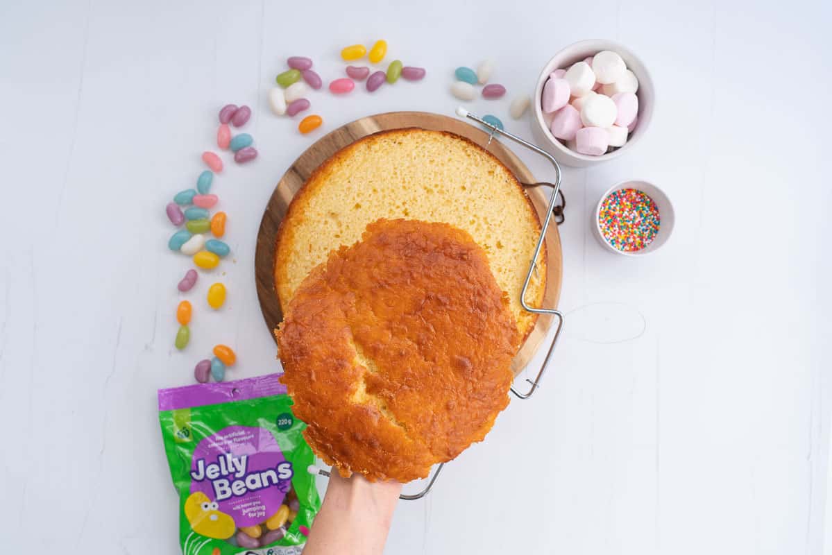 A round cake, top removed using a cake leveler.