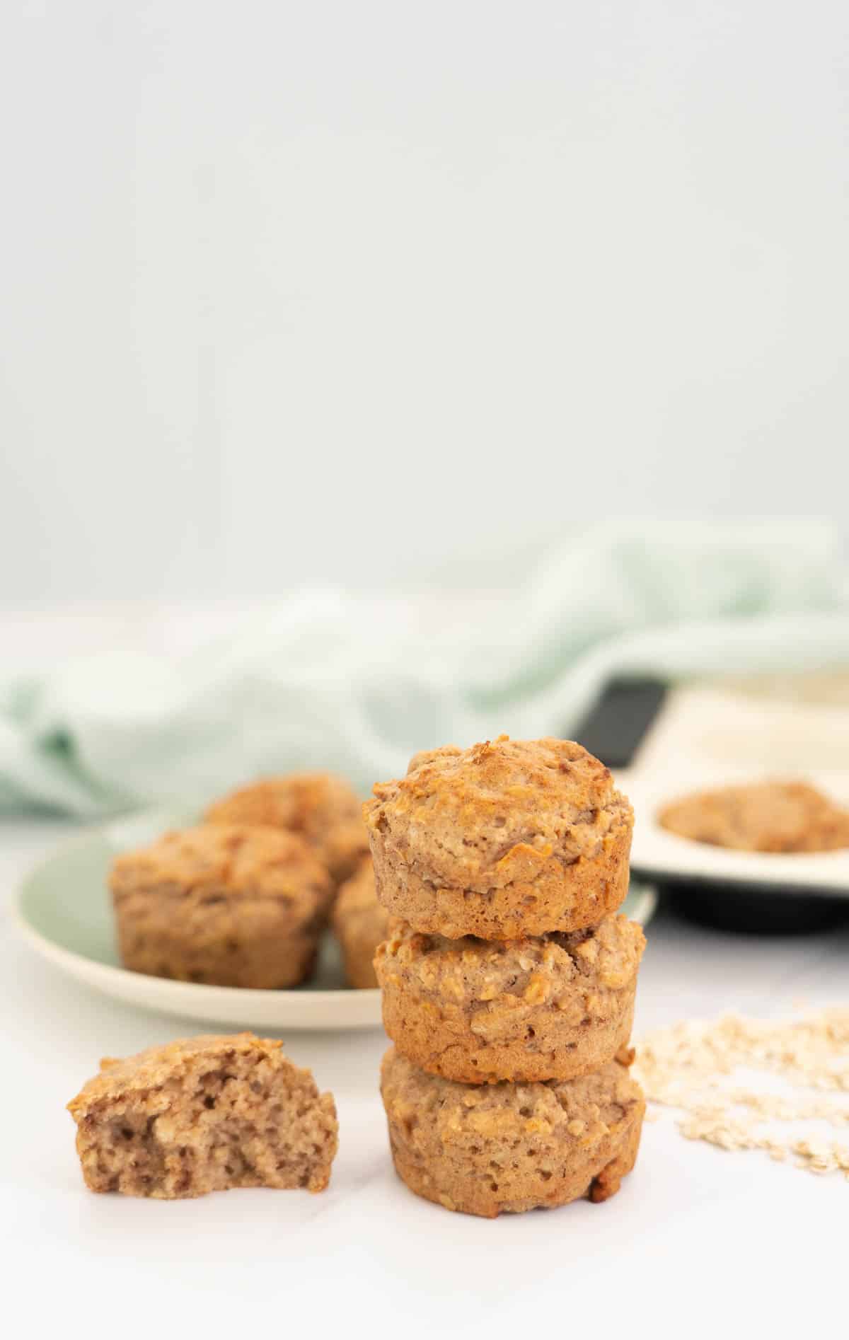 Three apple toddler muffins stacked in a tower.