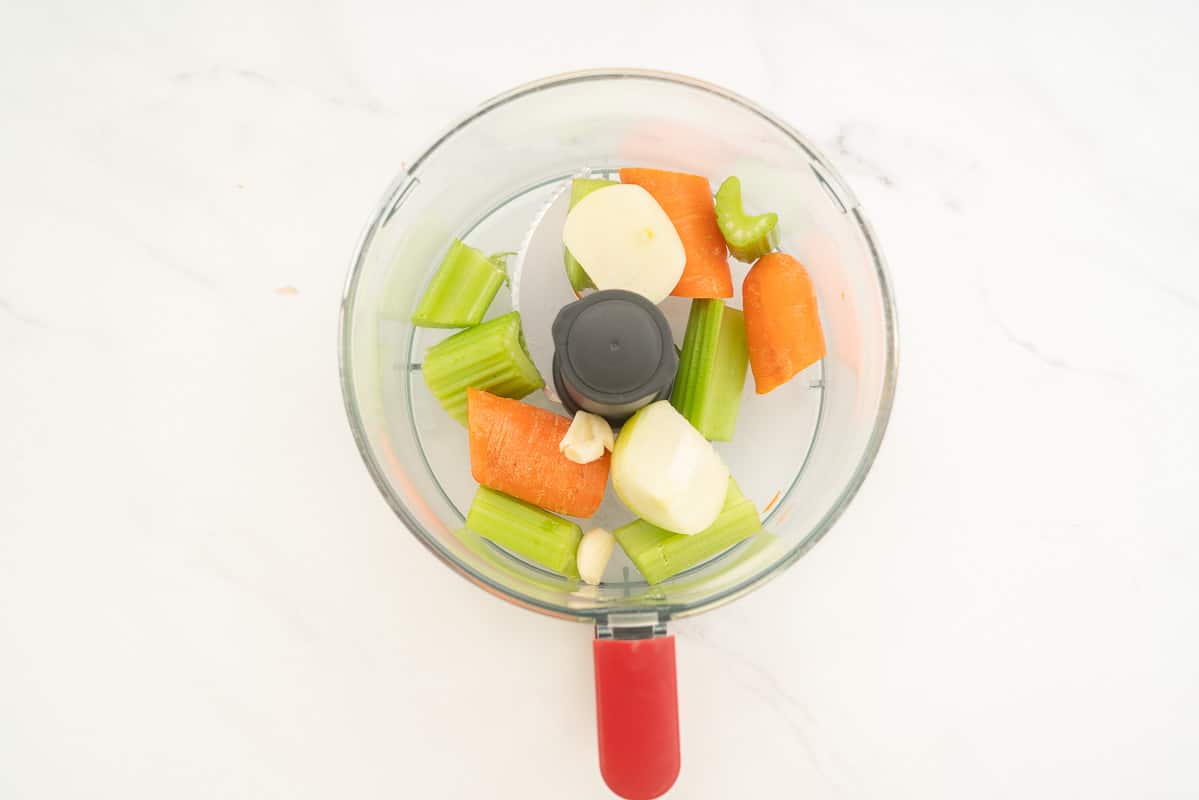 Roughly chopped onion, garlic, celery and carrot in a food processor.