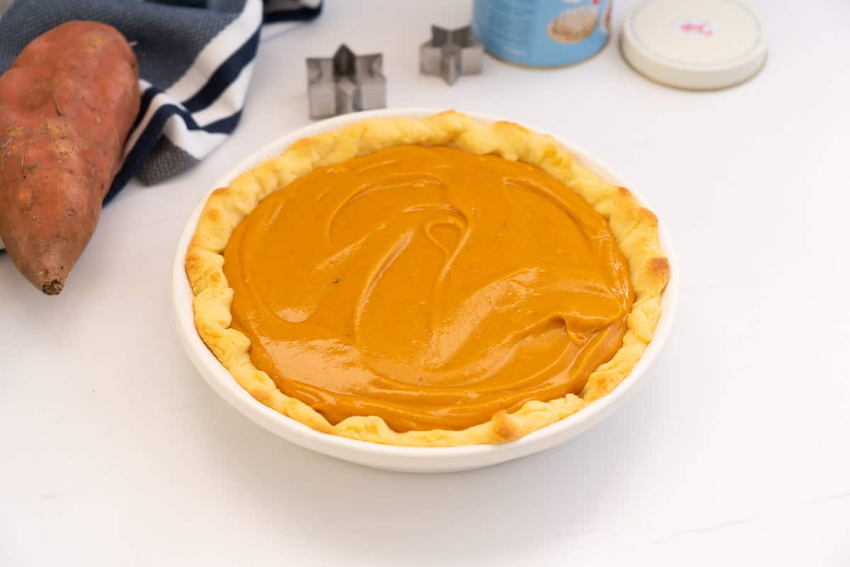 A pie crust filled with smooth sweet potato pie filling.