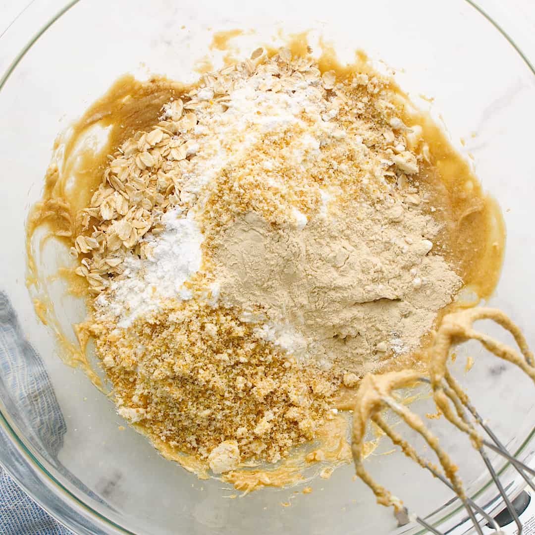 Dry ingredients being added to a glass mixing bowl