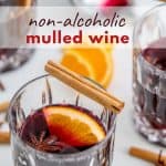 A cut glass tumbler filled with mulled wine with text overlay