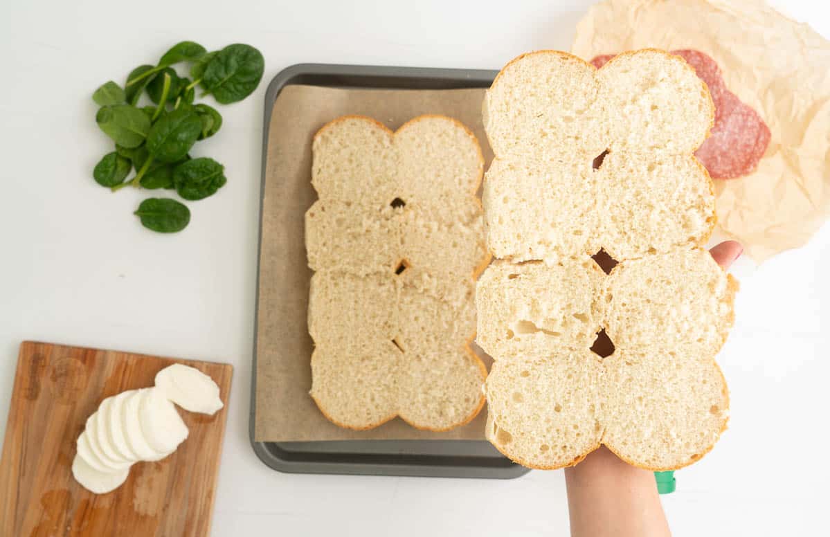 Eight slider buns that have been spilt in half horizontally.