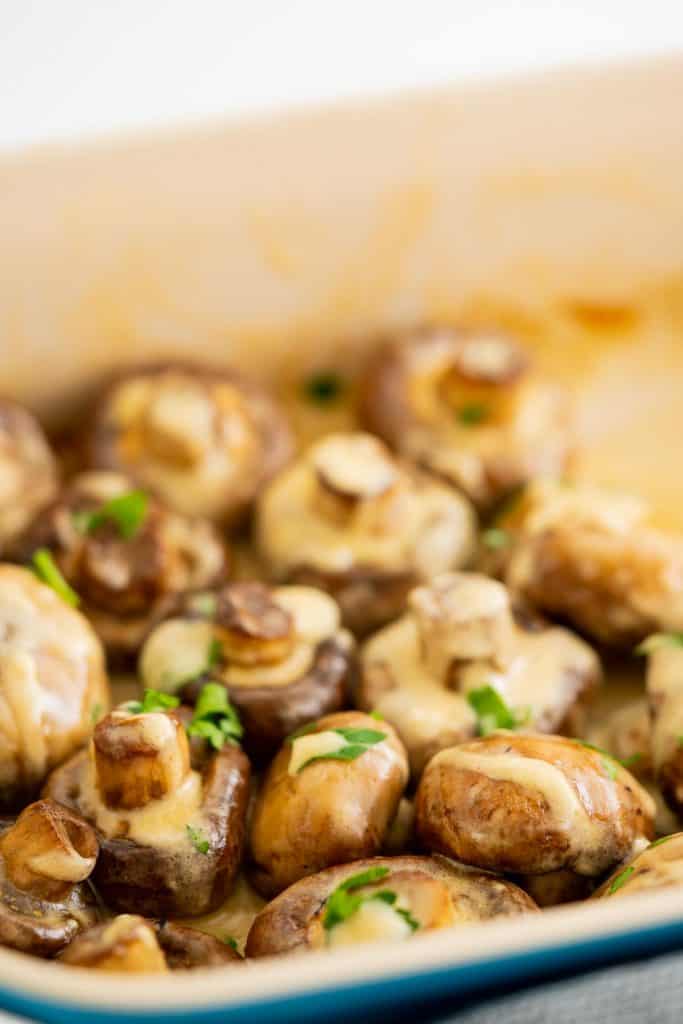 Mushrooms in a creamy sauce in a roasting dish.