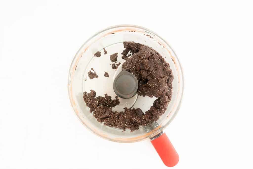 Chocolate bliss ball mix in a food processor.