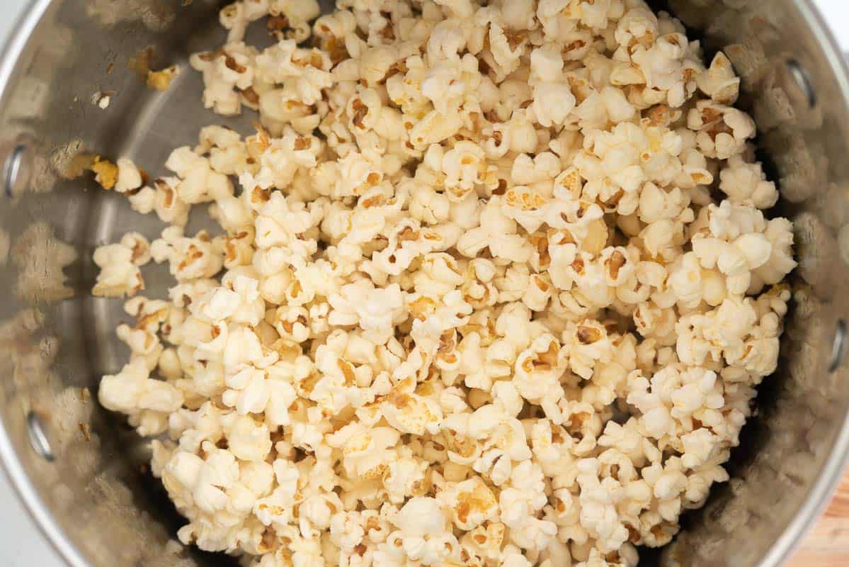 A large saucepan filled with popped popcorn.