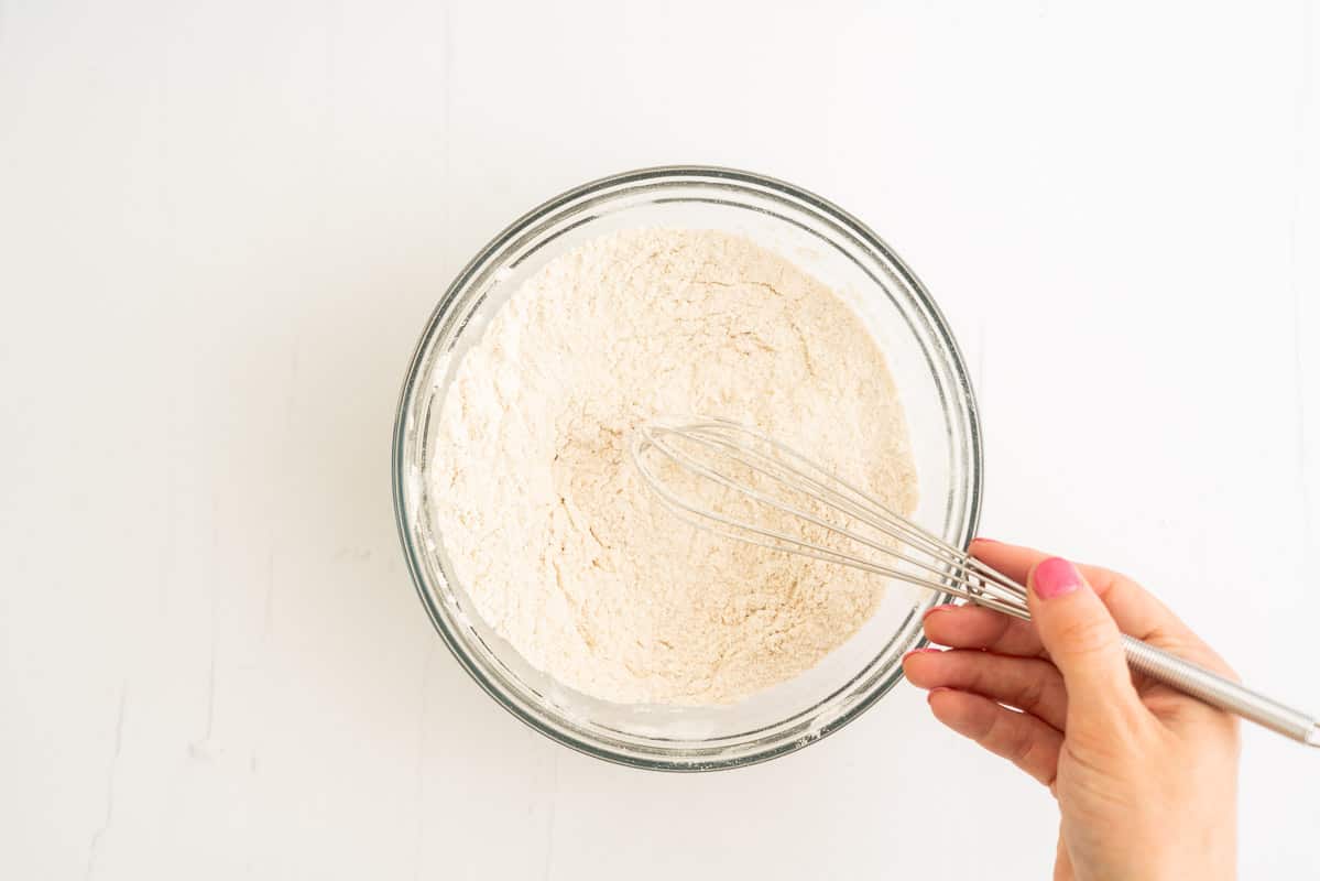 Dry ingredients whisked together in a glass bowl.