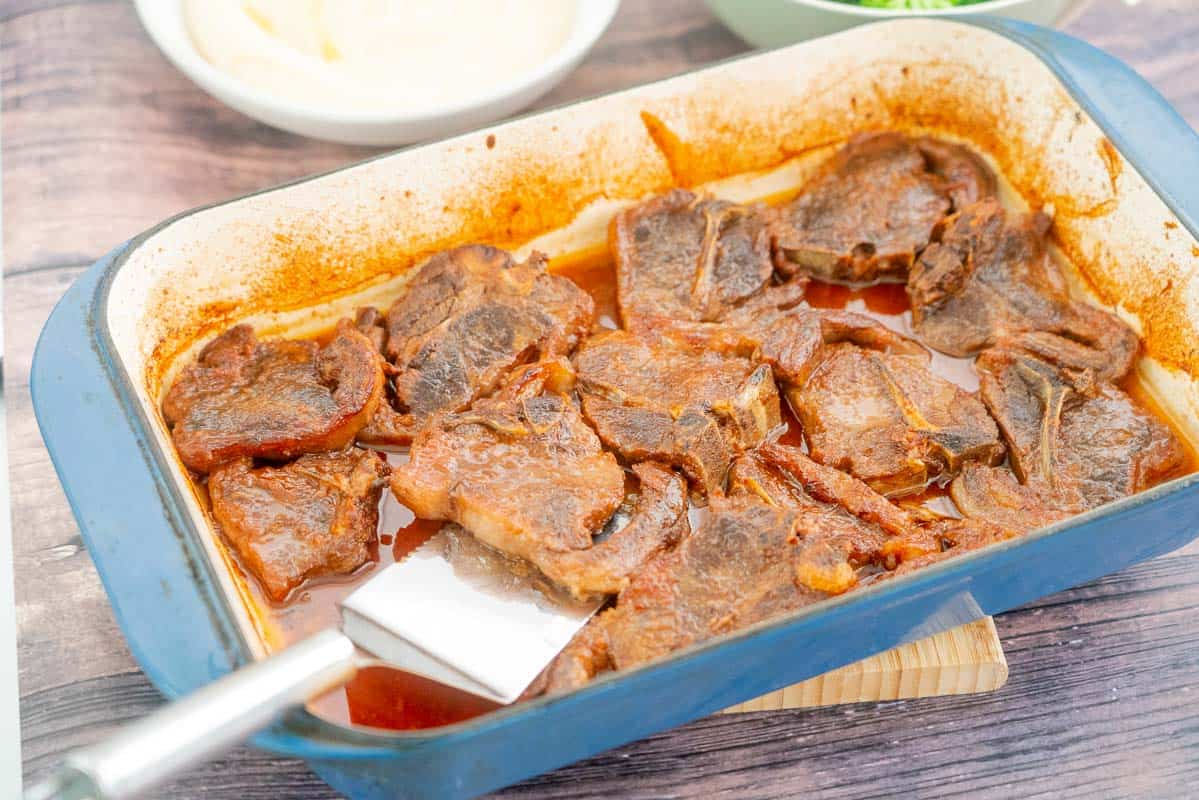 Sticky baked lamb chops in a ceramic dish ready to serve.
