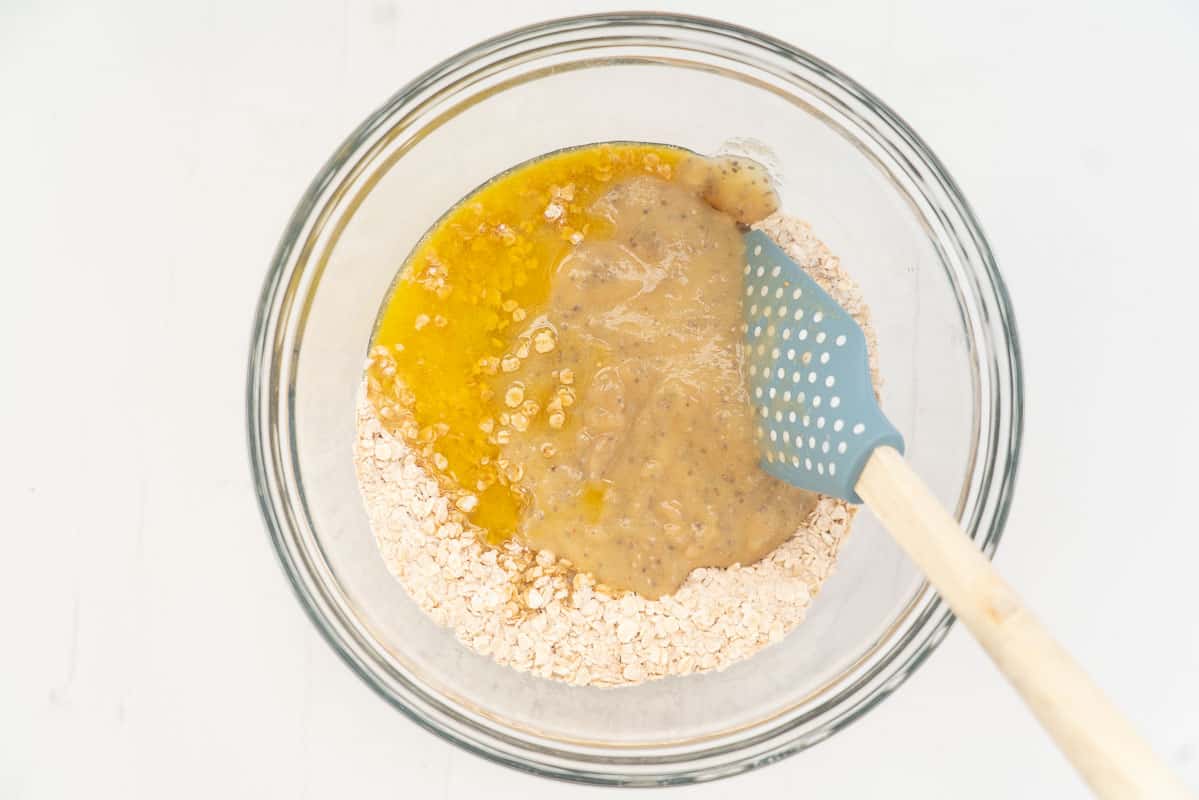 A mixing bowl of dry and wet cookie dough ingredients before mixing.