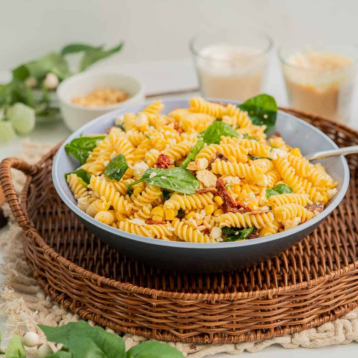 A blue ceramic serving bowl filled with colourful salad on a family dining table.