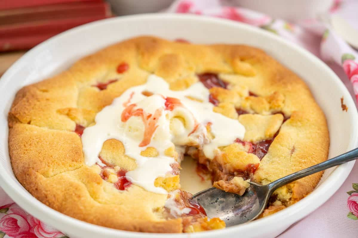 A pie with one slice removed, rhubarb filling visible.
