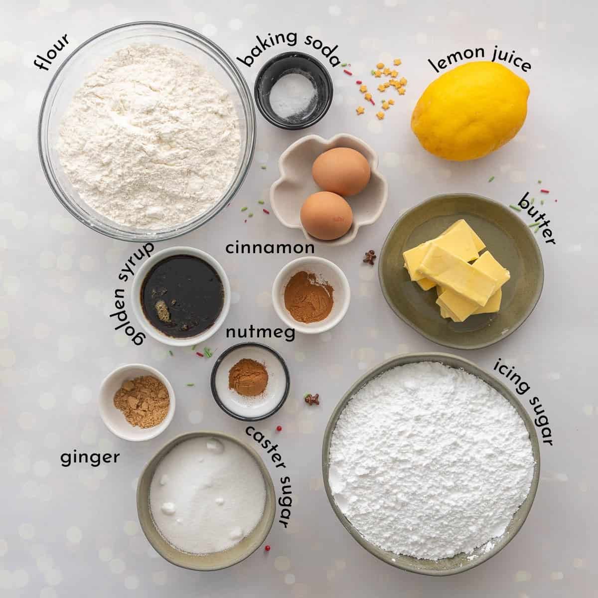 The ingredients to make gingerbread cookies laid out on a marble counter top with text overlay,