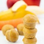 A tower of three mini muffins with apple, banana and carrots in the background with text overlay
