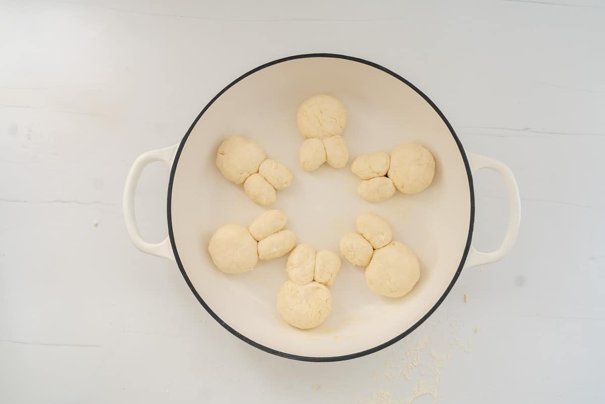 6 bunny buns in an oven proof dish ready to go in the oven.