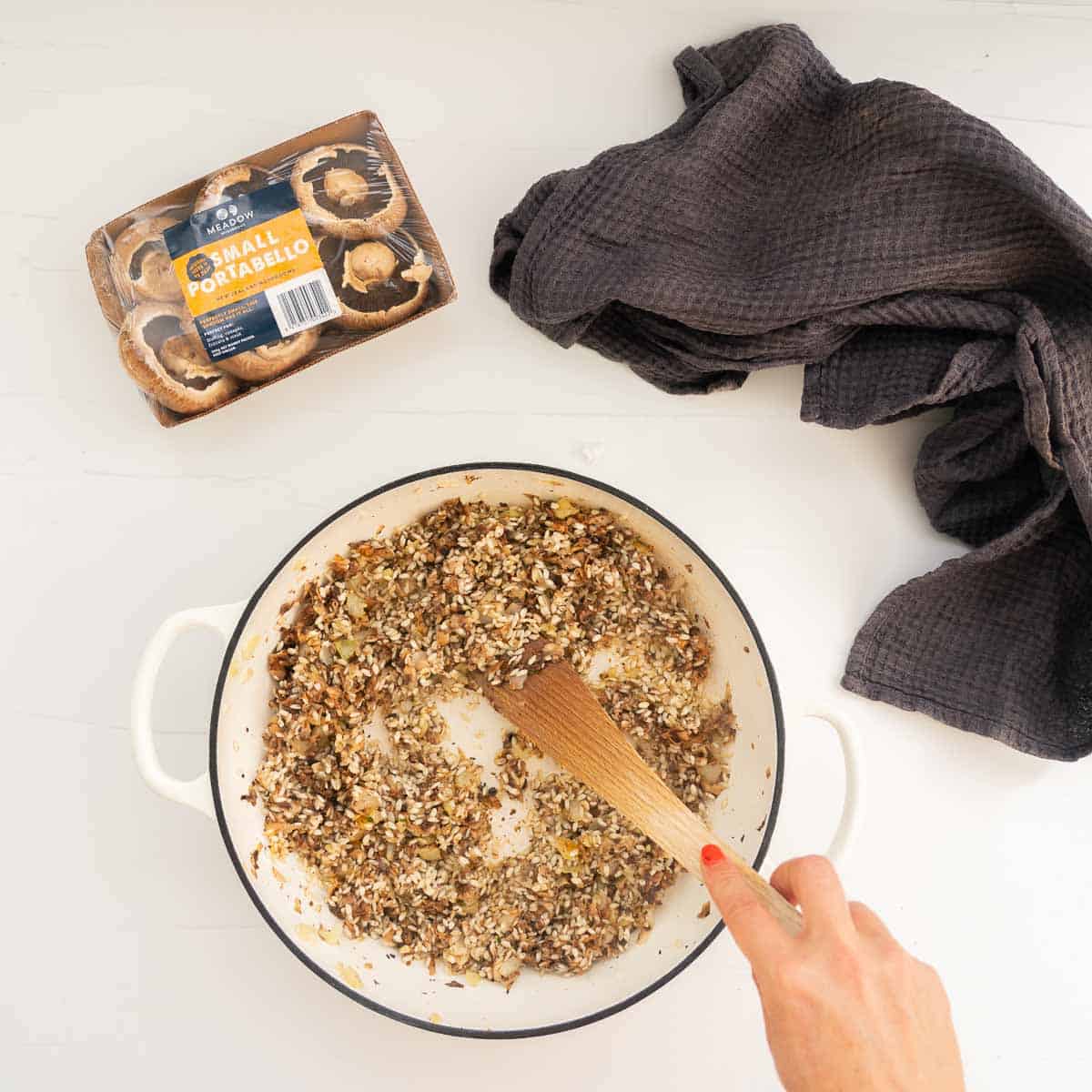 Arborio rice and grated mushrooms being sautéed