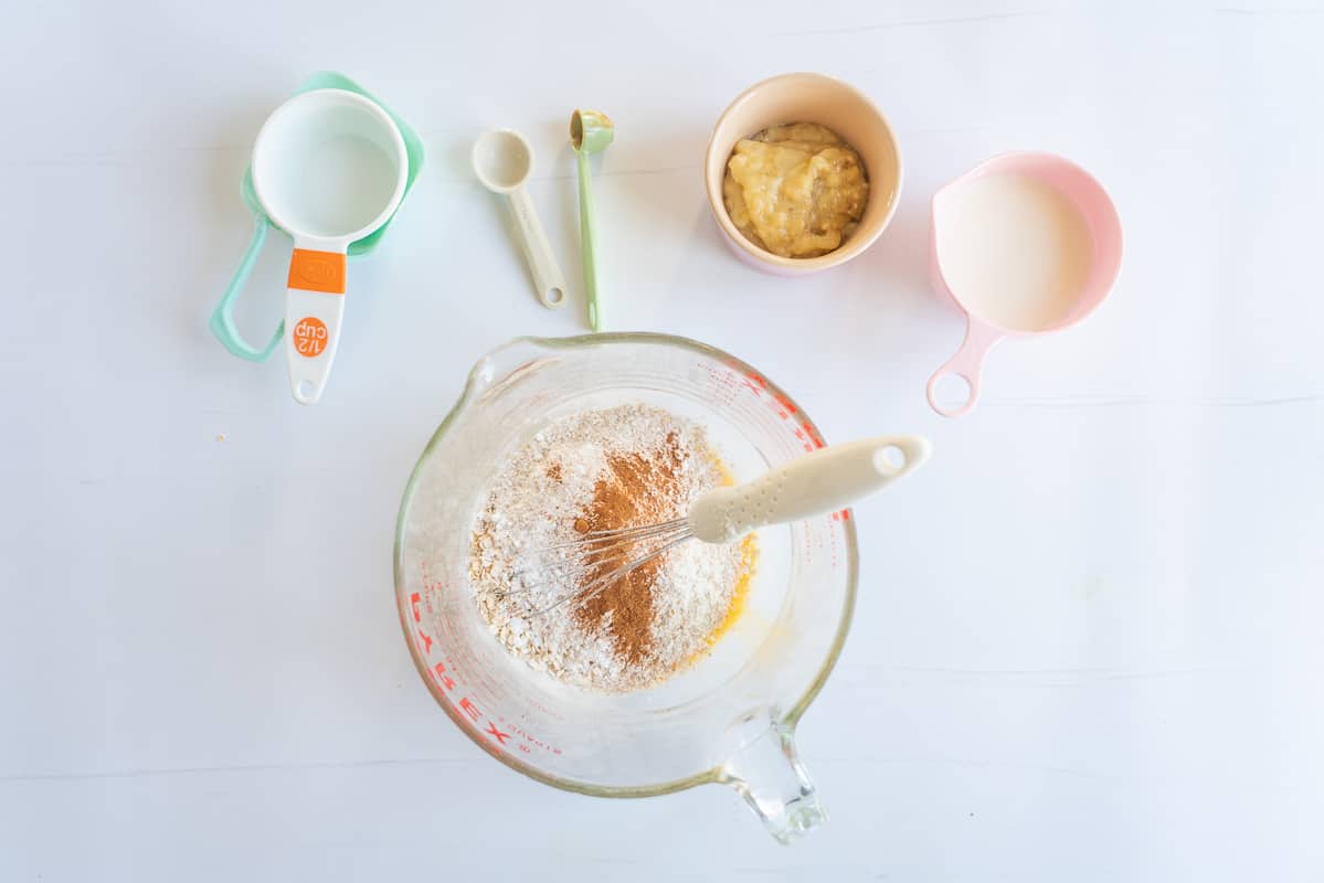Dry ingredients in a glass mixing jug, waiting to be combined.