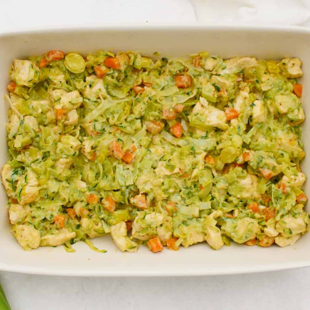Chicken and leek pie filling in a rectangular pie dish.