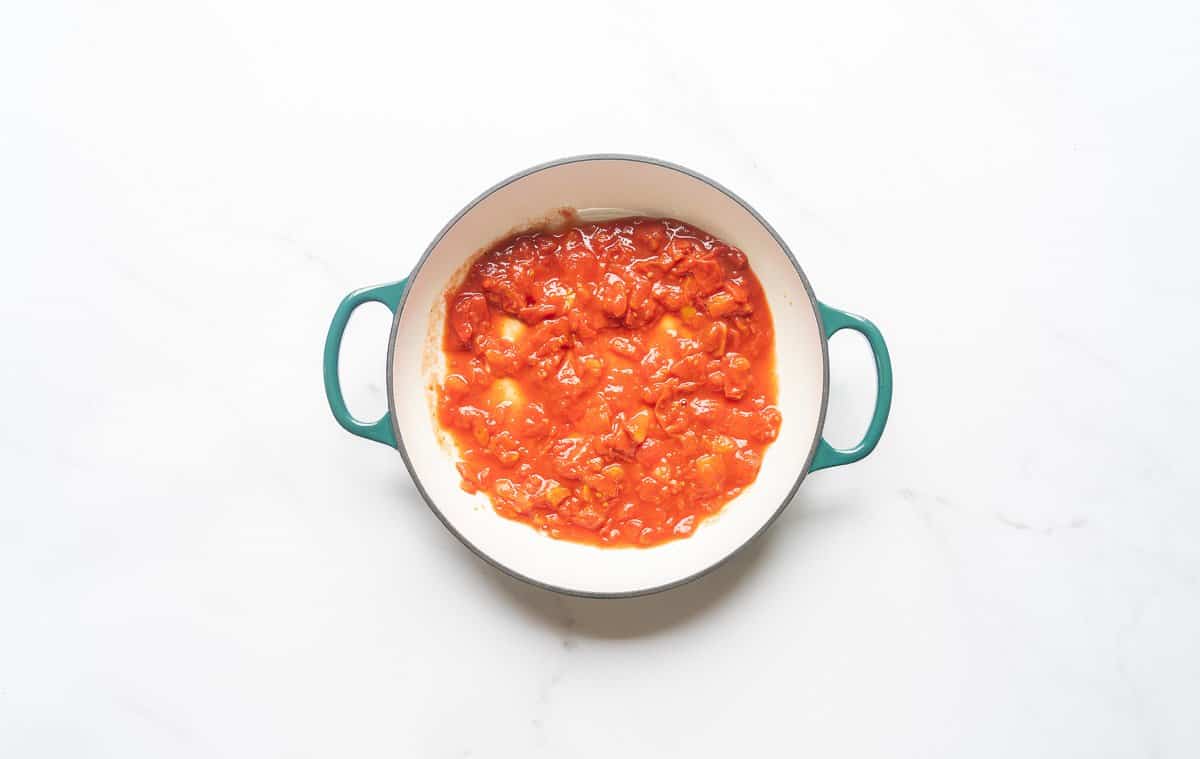 Diced tomatoes in the bottom of a large casserole dish.